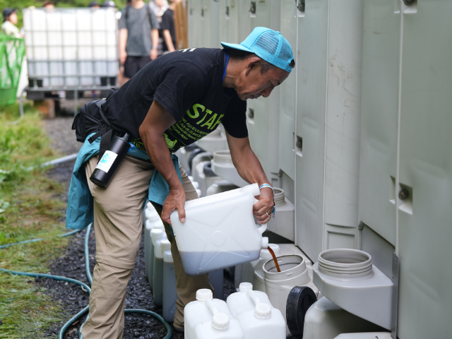 Poring AEM into the sewage tank.