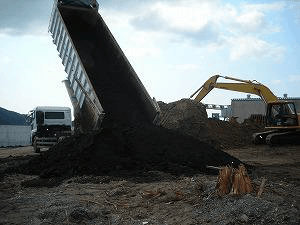 View of discharging compost and spraying EM・1® into the hole of organic waste